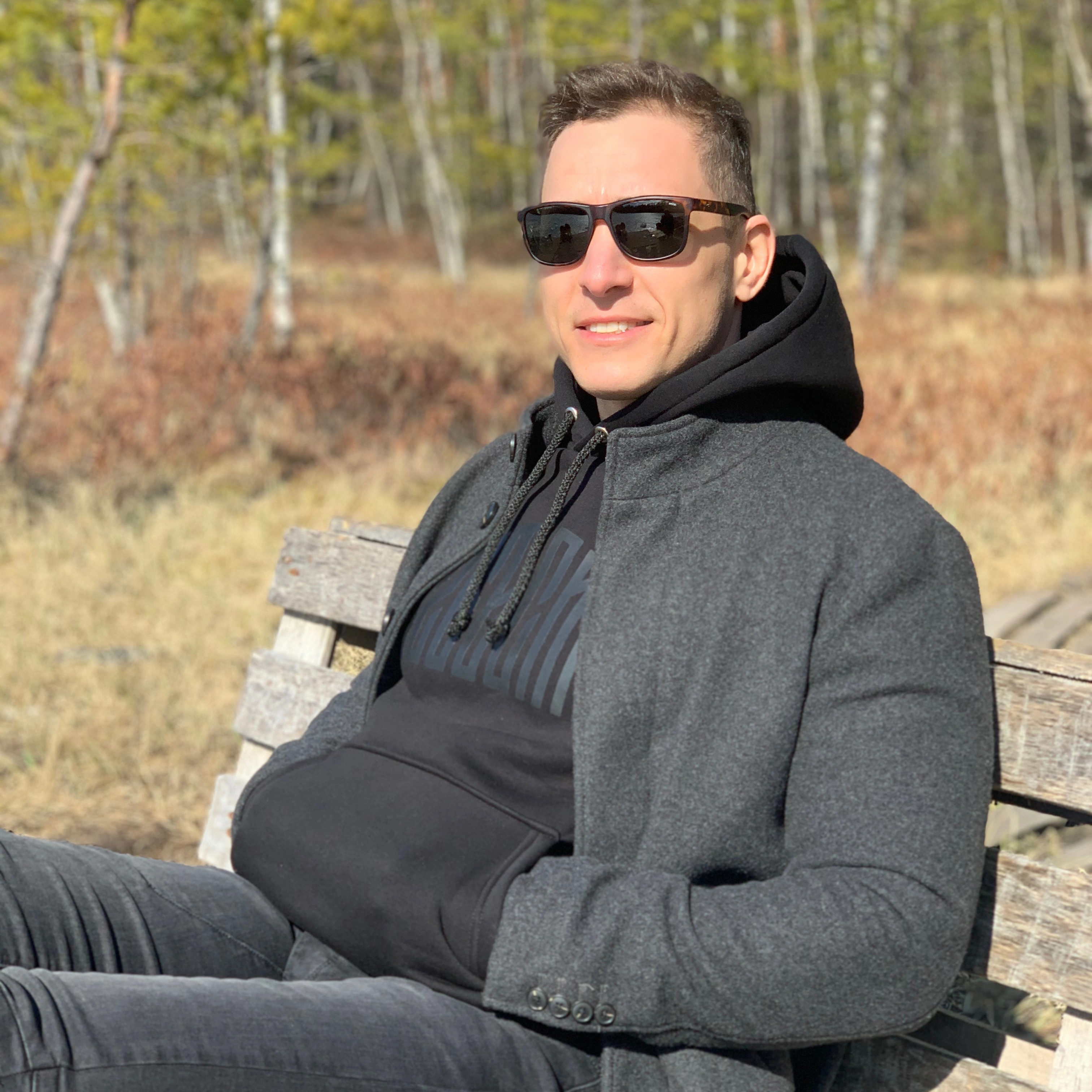 satisfied ADU Now LA client relaxing outdoors after successful ADU construction project