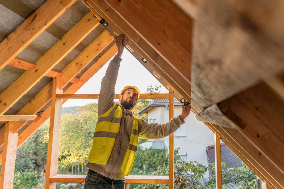 ADU Now LA contractor measuring roof framing during accessory dwelling unit construction in Los Angeles